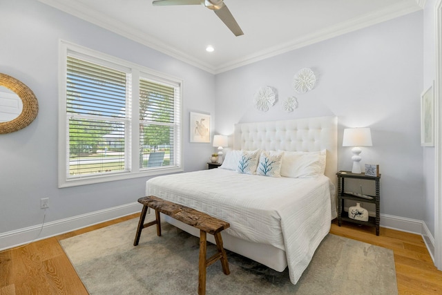 bedroom featuring hardwood / wood-style floors, ceiling fan, and crown molding