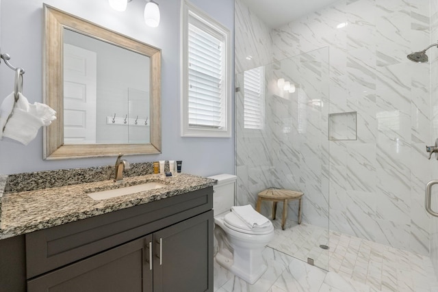 bathroom with a healthy amount of sunlight, tile floors, a shower with shower door, and large vanity