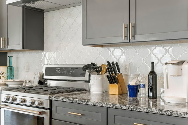 kitchen featuring gray cabinets, tasteful backsplash, and high end stainless steel range oven