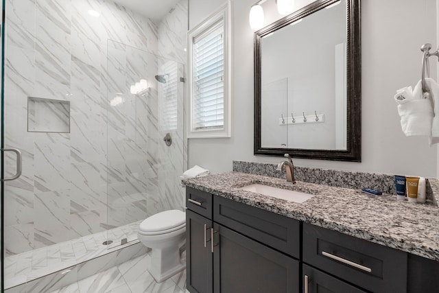 bathroom featuring walk in shower, tile floors, vanity with extensive cabinet space, and toilet