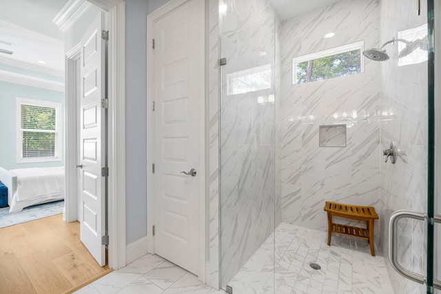 bathroom featuring tile floors and a tile shower