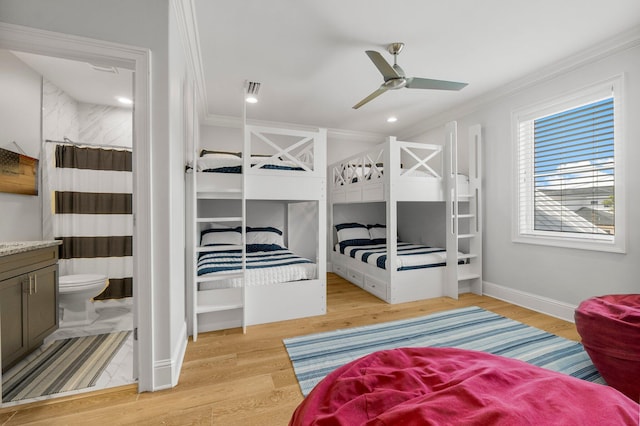 bedroom with ornamental molding, ceiling fan, and light wood-type flooring