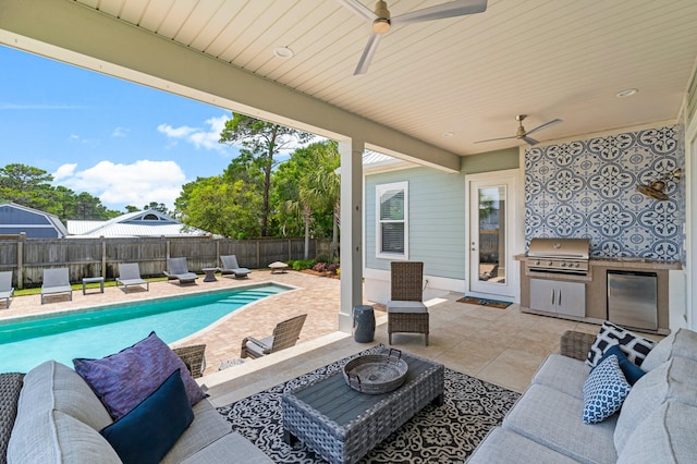 view of terrace featuring a grill, an outdoor kitchen, ceiling fan, an outdoor living space, and a fenced in pool