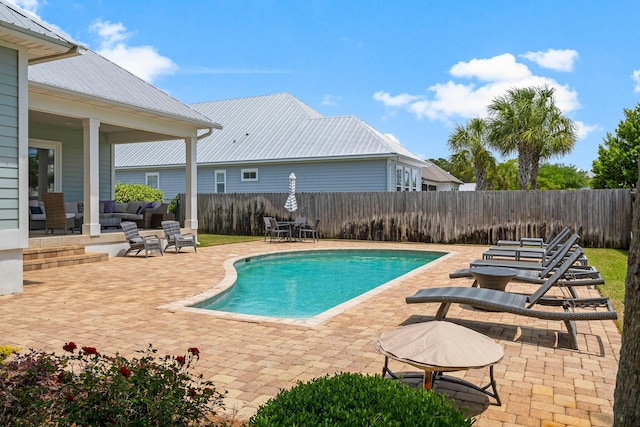 view of swimming pool with a patio area and an outdoor living space