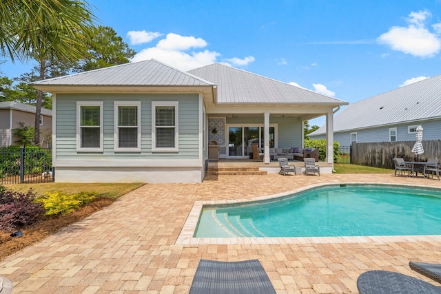 back of house featuring a fenced in pool, a patio, and ceiling fan