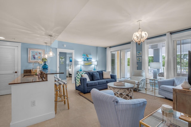 tiled living room featuring sink and a chandelier