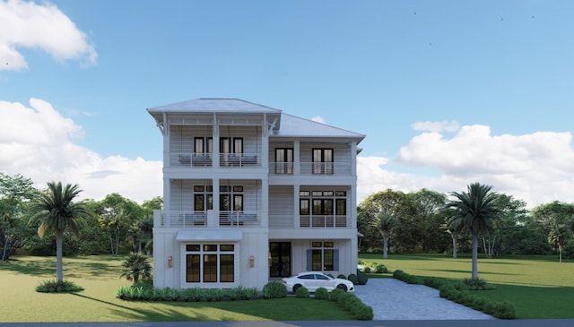 view of front facade with a front yard and a balcony