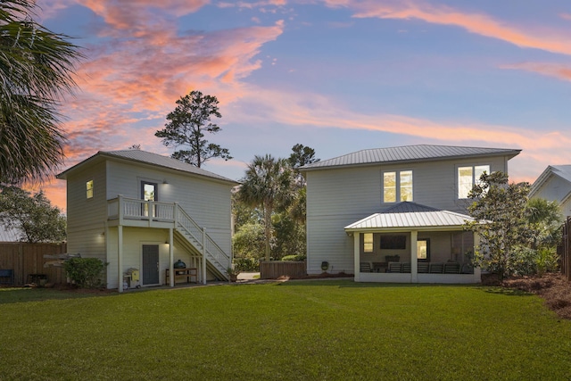 back house at dusk with a yard