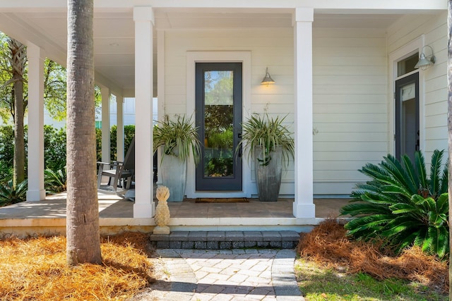 view of exterior entry featuring a porch