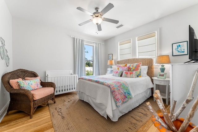 bedroom with ceiling fan and light wood-type flooring