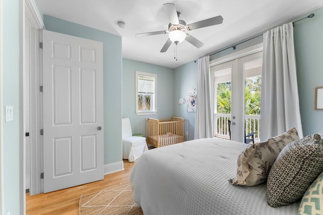 bedroom with light hardwood / wood-style flooring, ceiling fan, access to outside, and multiple windows