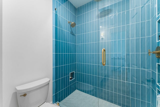 bathroom with tiled shower and toilet