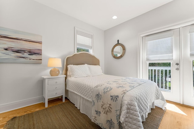 bedroom featuring multiple windows and dark wood-type flooring