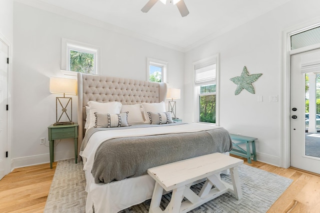 bedroom with access to outside, light wood-type flooring, ceiling fan, and multiple windows