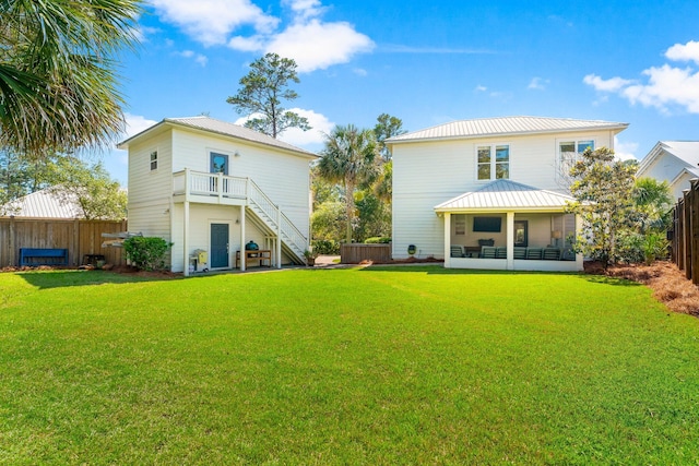 rear view of property with a lawn