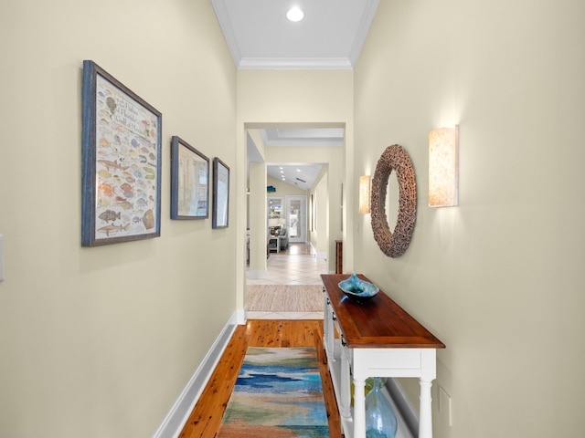 corridor with hardwood / wood-style floors and ornamental molding