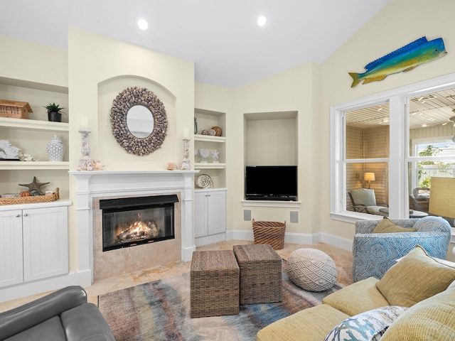 tiled living room with built in features, a tile fireplace, and lofted ceiling