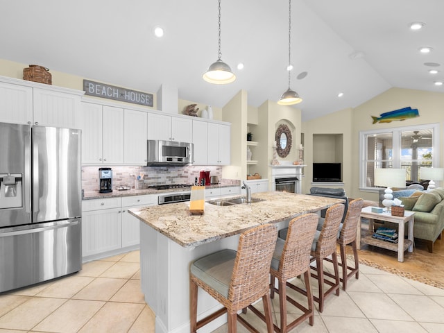 kitchen featuring appliances with stainless steel finishes, white cabinetry, and light tile floors