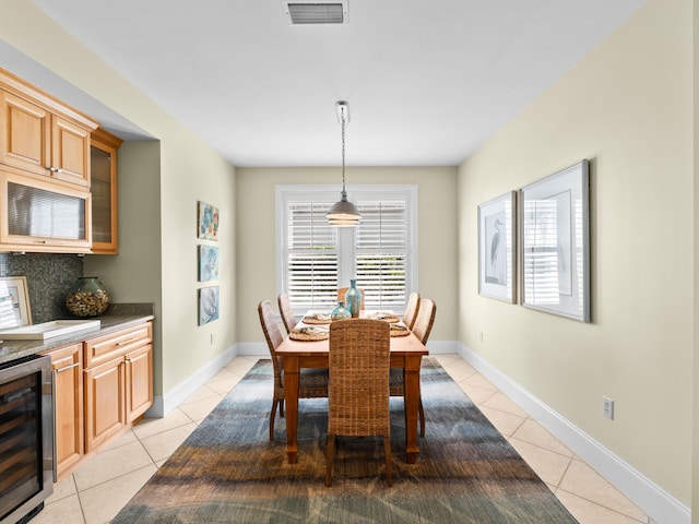 dining area featuring light tile floors and beverage cooler