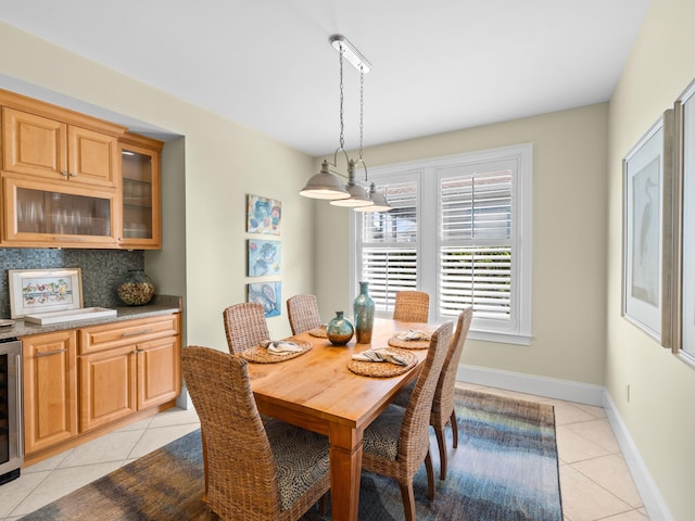 dining area with light tile floors and beverage cooler