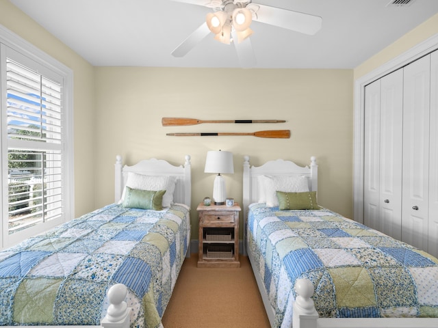 bedroom with carpet flooring, a closet, and ceiling fan