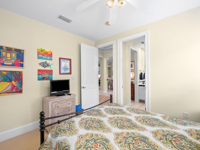 tiled bedroom with ceiling fan and ensuite bathroom