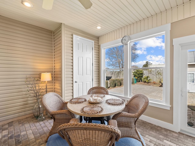 sunroom / solarium featuring a wealth of natural light and ceiling fan