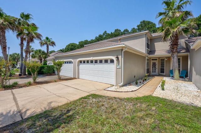 front of property with a garage and french doors