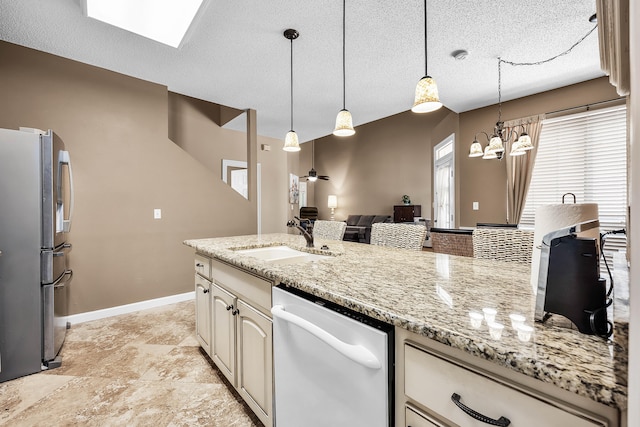 kitchen featuring hanging light fixtures, sink, stainless steel appliances, and light tile floors