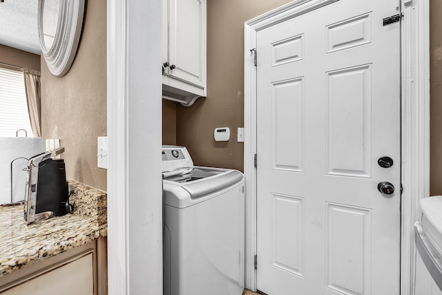 laundry room with cabinets and washer / clothes dryer