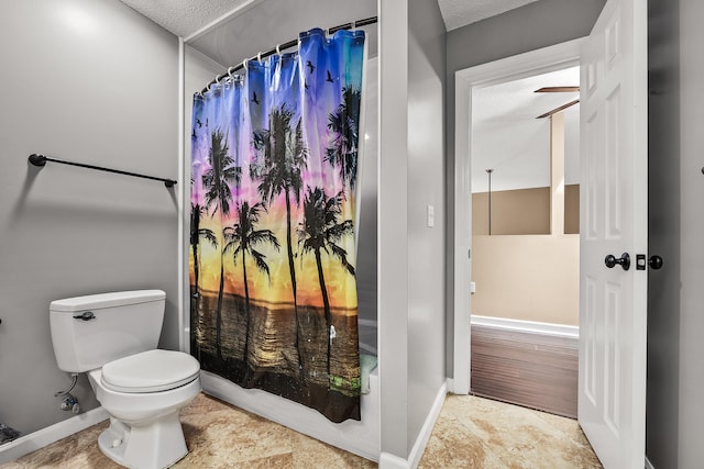 bathroom with tile floors, a textured ceiling, and toilet