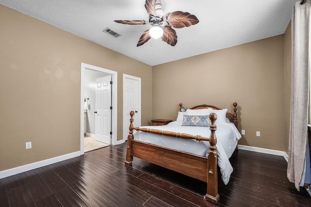 bedroom with a textured ceiling, ceiling fan, connected bathroom, and hardwood / wood-style floors