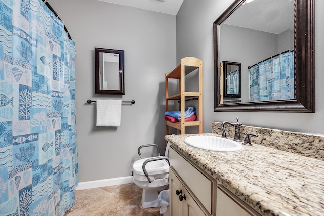 bathroom with vanity with extensive cabinet space, toilet, and tile floors