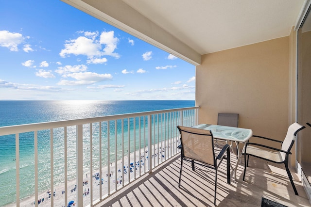 balcony featuring a water view and a view of the beach