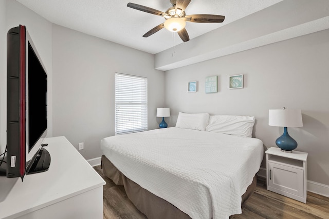 bedroom featuring ceiling fan and dark hardwood / wood-style floors