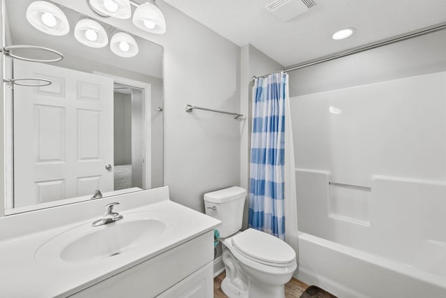 full bathroom featuring shower / bathtub combination with curtain, toilet, a textured ceiling, and large vanity