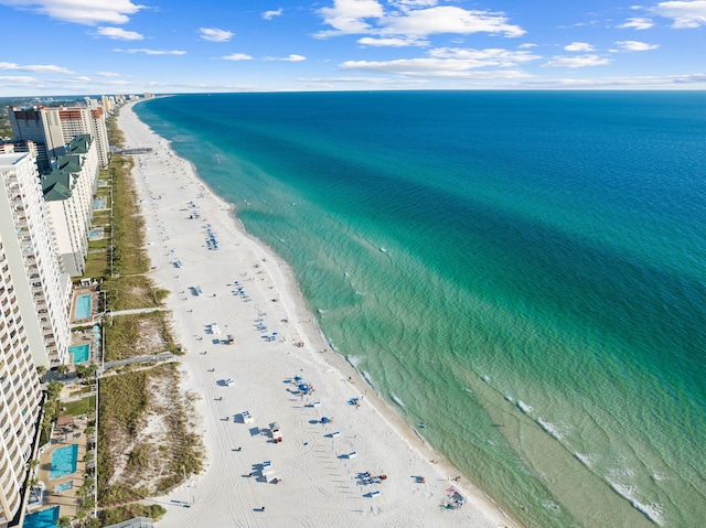 bird's eye view featuring a water view and a beach view