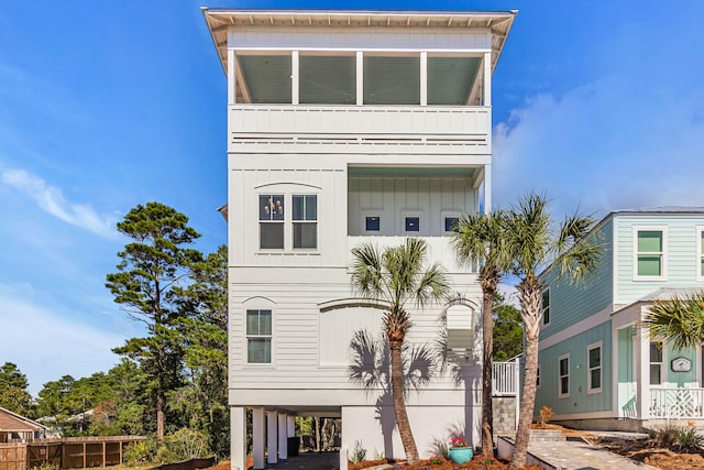 view of front of property with a balcony and a carport