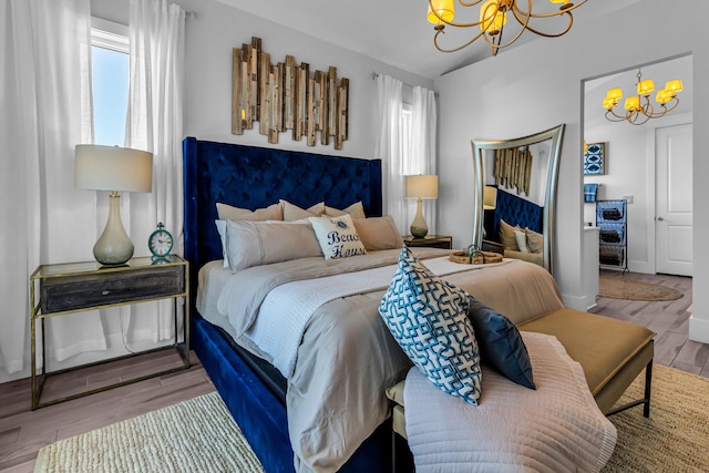 bedroom featuring hardwood / wood-style floors and a chandelier