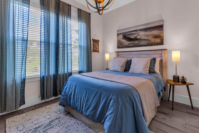 bedroom with a chandelier and hardwood / wood-style flooring