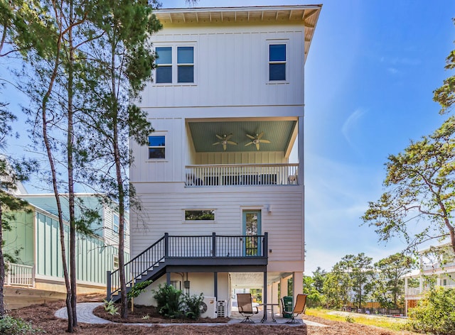 back of house featuring a balcony and ceiling fan