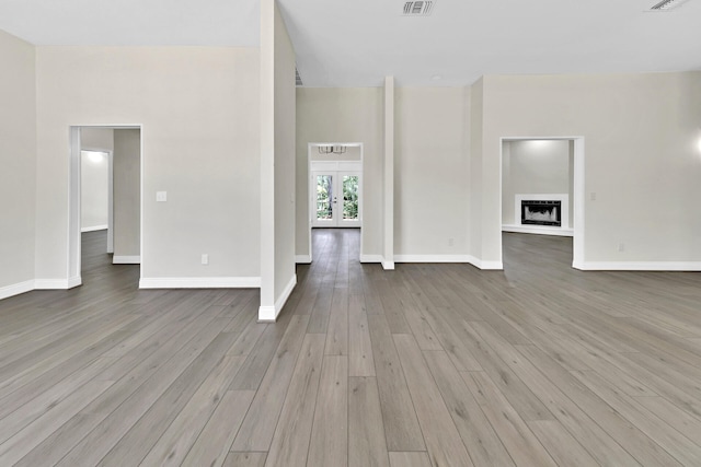 unfurnished living room with french doors and hardwood / wood-style flooring