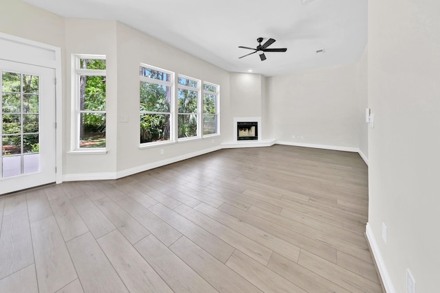 spare room with ceiling fan and light wood-type flooring