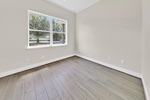 unfurnished room with vaulted ceiling, a healthy amount of sunlight, hardwood / wood-style flooring, and crown molding