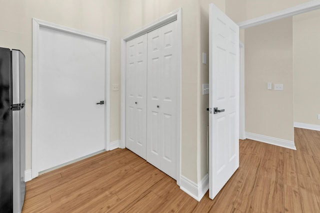 corridor with light hardwood / wood-style flooring