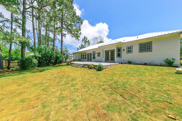 rear view of property with a yard