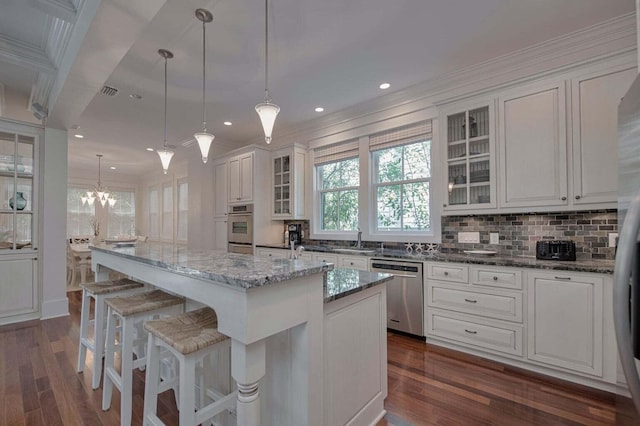 kitchen featuring stainless steel dishwasher, dark hardwood / wood-style flooring, and white cabinets