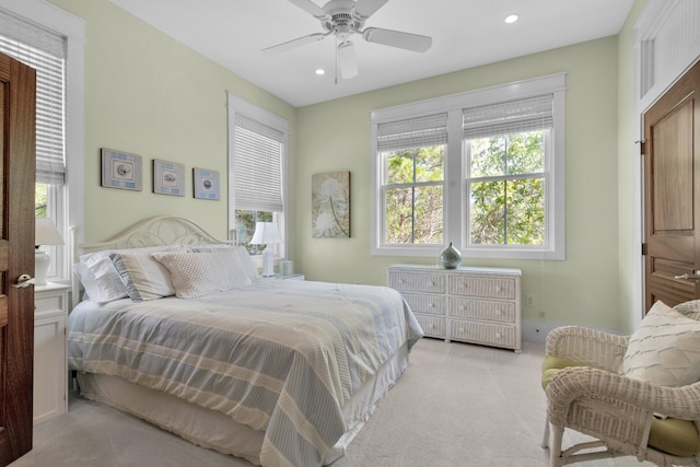 bedroom featuring light carpet and ceiling fan