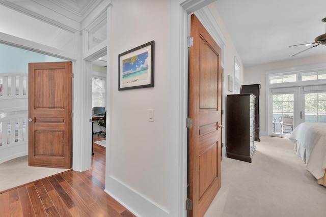 hallway with carpet floors and beam ceiling