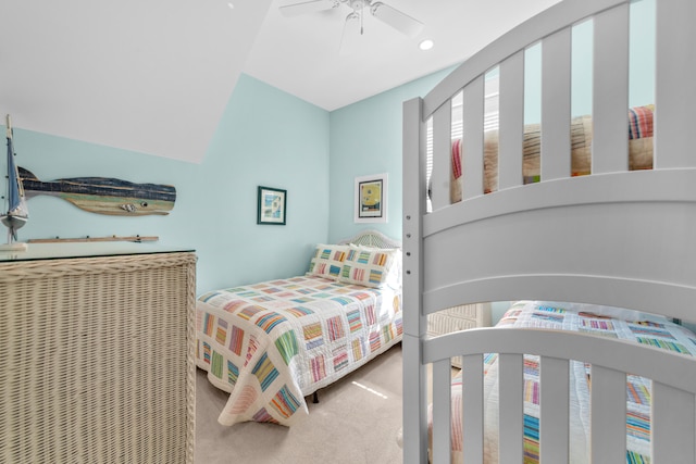 carpeted bedroom featuring lofted ceiling and ceiling fan